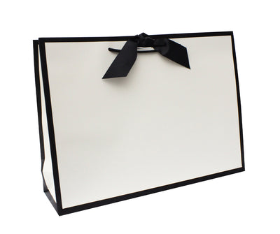 A large landscape-oriented luxury gift bag with a black edge and a matt lamination finish. It includes a black grosgrain ribbon with rope handles, positioned upright against a white background.  gift bags,
paper gift bags ,
large gift bags ,
